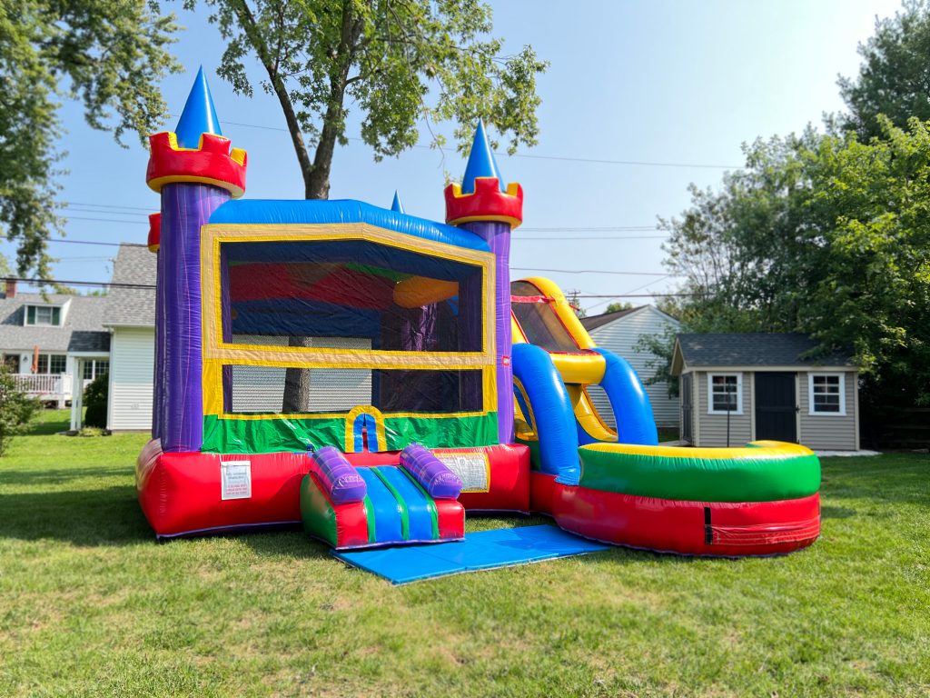 bright and colorful 2 in 1 bounce house and waterslide combo rental at a backyard event set up on grass