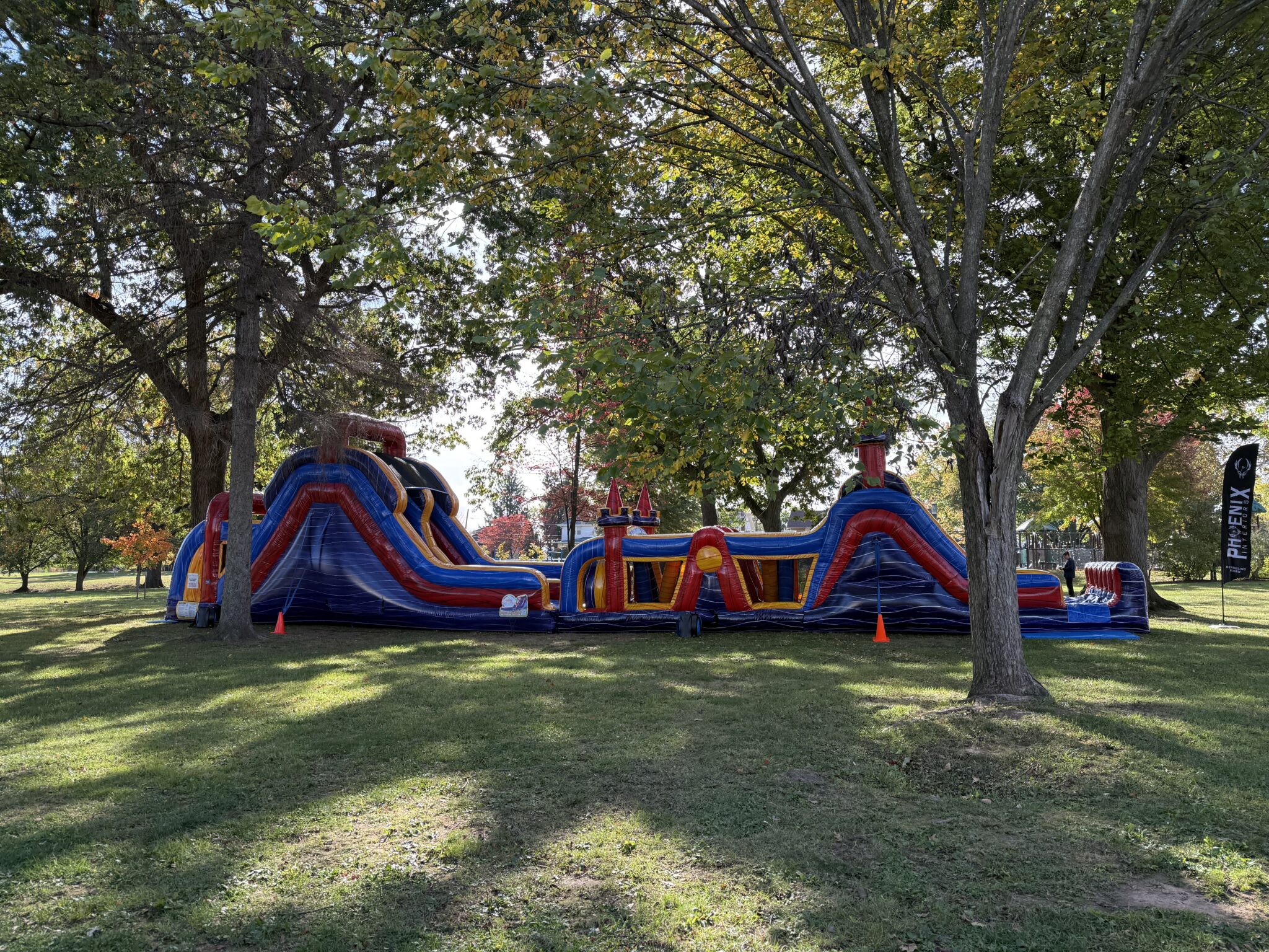 infaltable obstacle course set in grass near trees
