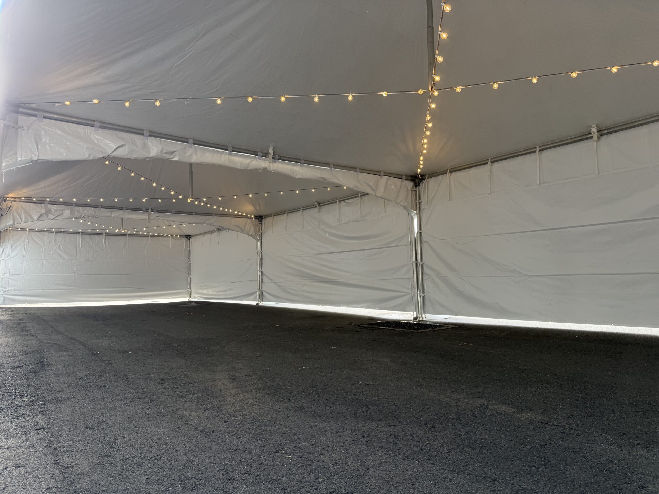 inside a 20x60 tent rental with sting lights hung