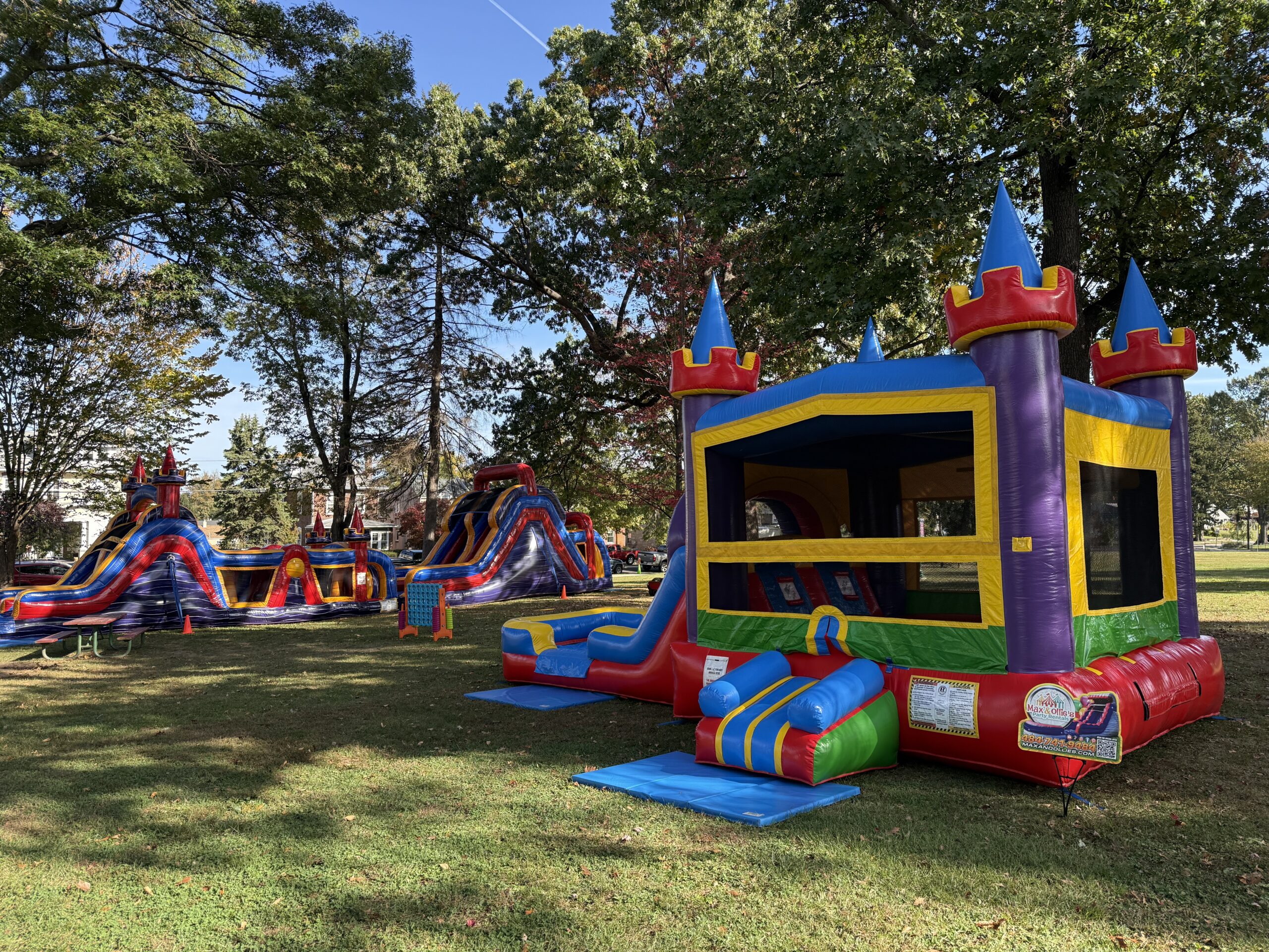 multiple inflatable rentals set up at a park